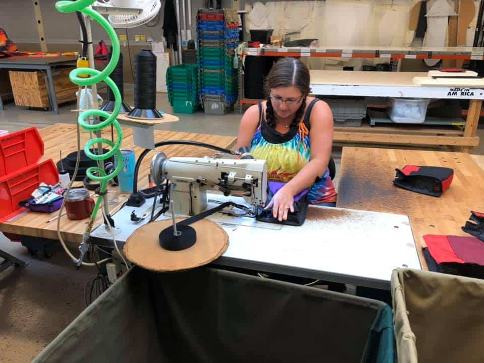 A machinist at Red Oxx - working on the bag inside out